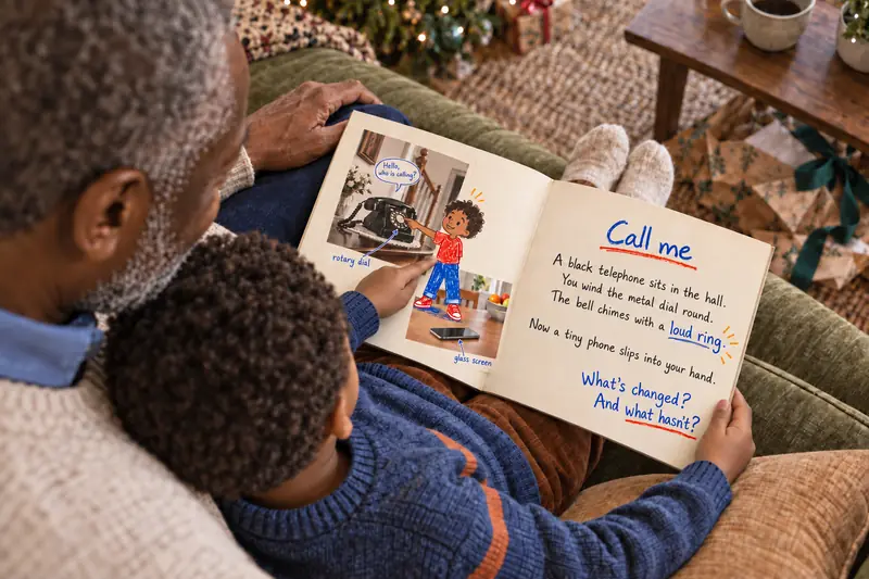 A boy pointing at himself in the illustration, the book open in front of him.